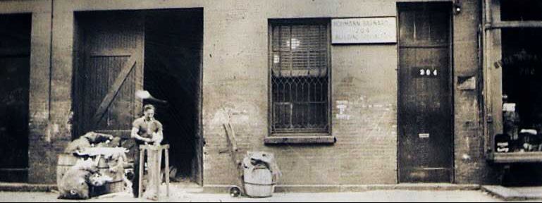 image of man working in front of brick warehouse